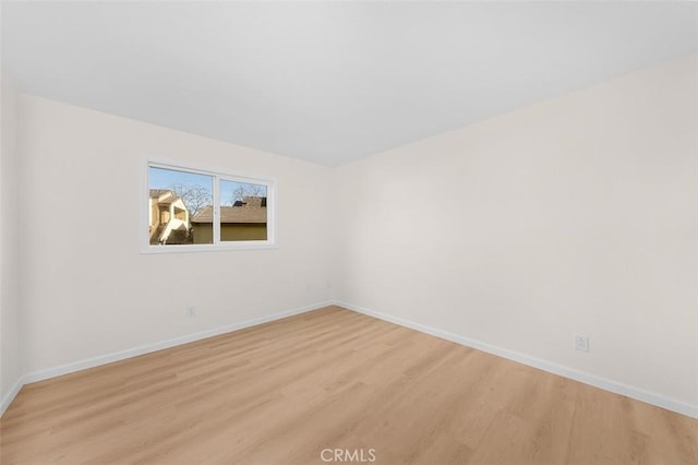 spare room with light hardwood / wood-style flooring