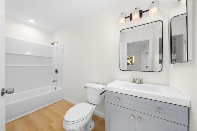 full bathroom featuring hardwood / wood-style flooring, toilet, vanity, and bathing tub / shower combination