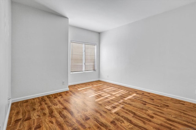 unfurnished room featuring hardwood / wood-style flooring