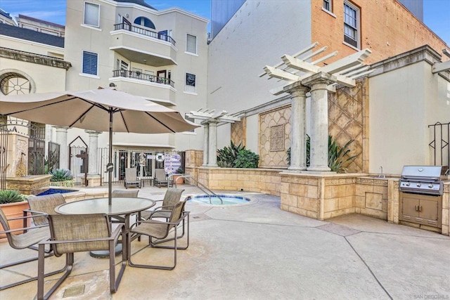 view of patio with a pergola and area for grilling