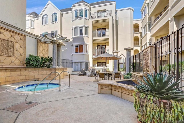 view of pool with a patio area and a community hot tub