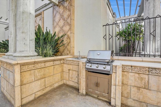 view of patio / terrace featuring exterior kitchen, sink, and a grill