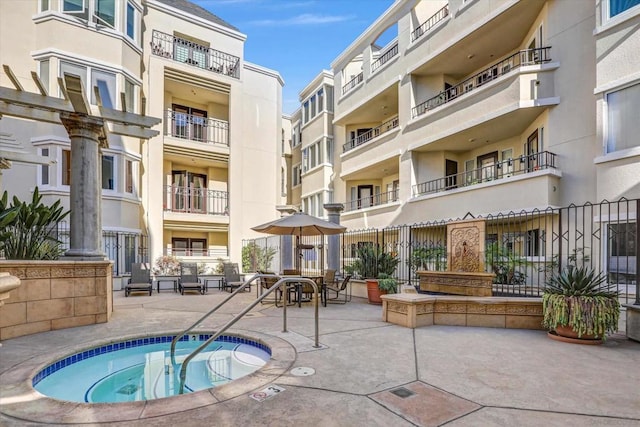 view of swimming pool featuring a hot tub