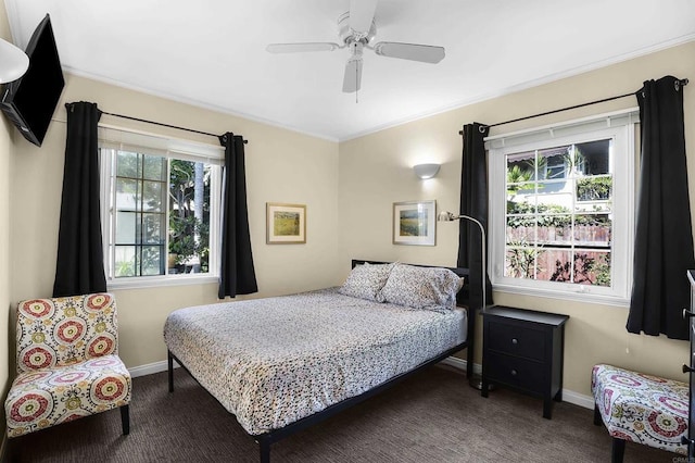 bedroom featuring ceiling fan and dark carpet