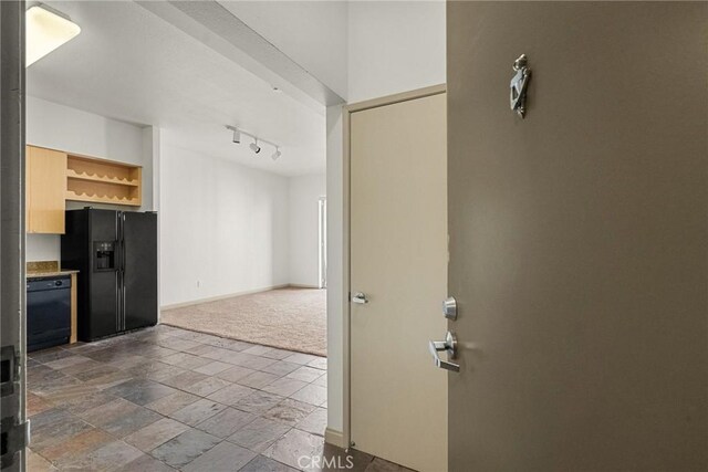 interior space with dark carpet and black appliances