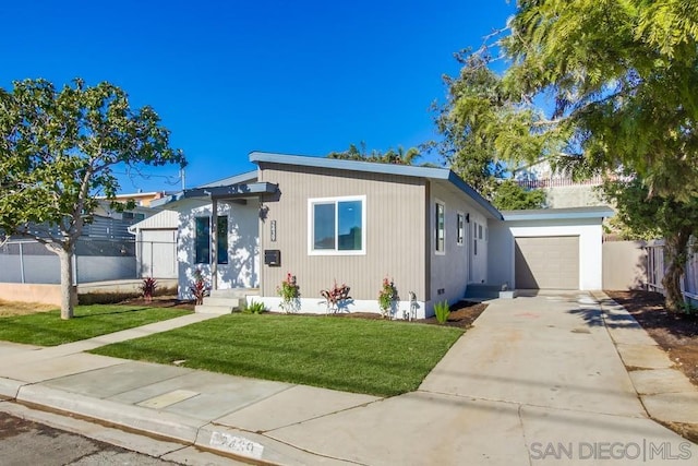 view of front of home with a front yard and a garage