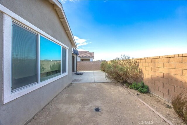 view of side of home with a patio area