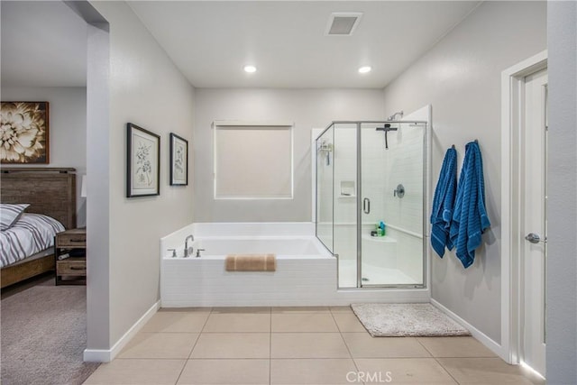 bathroom featuring tile patterned flooring and shower with separate bathtub