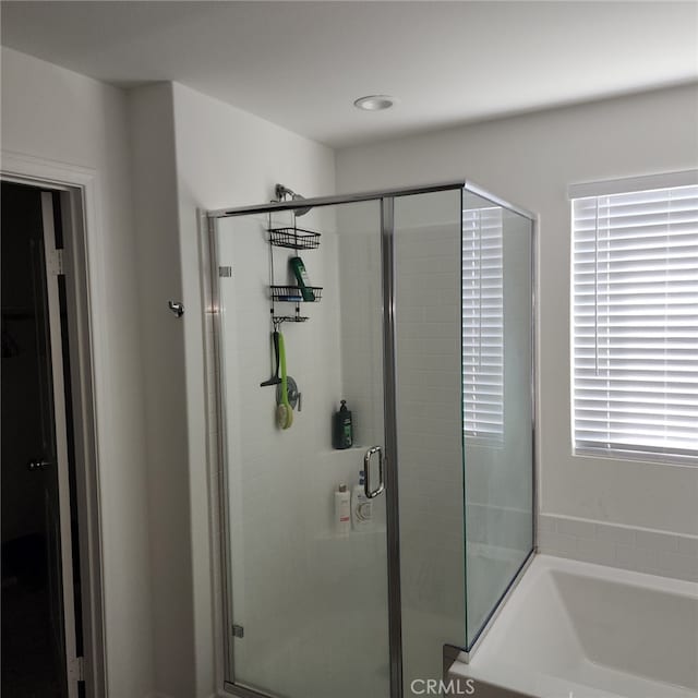 bathroom with shower with separate bathtub