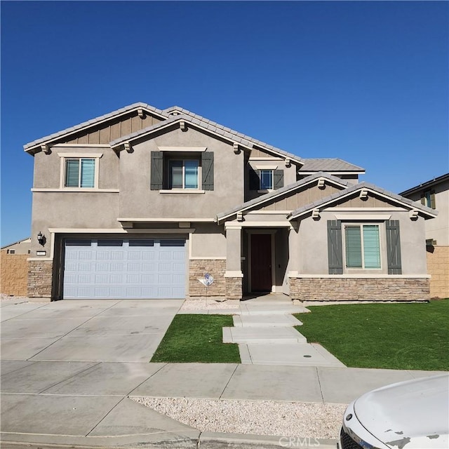 view of front of home with a front lawn and a garage