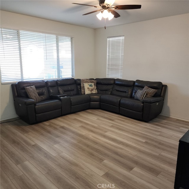 living room featuring ceiling fan and light wood-type flooring