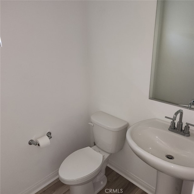 bathroom with sink, wood-type flooring, and toilet