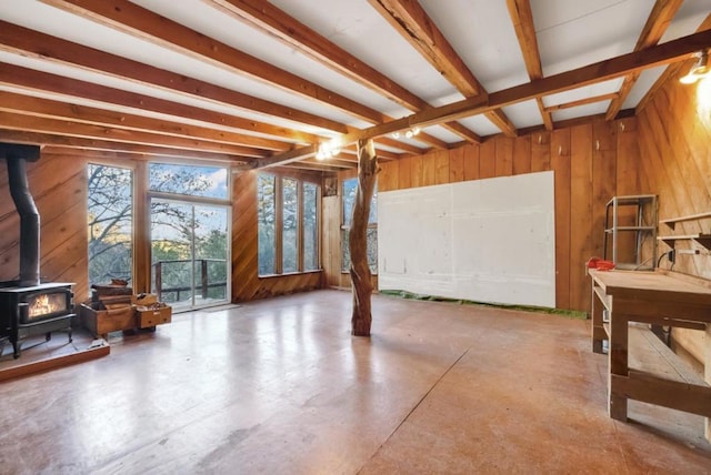 interior space featuring a wood stove and wood walls