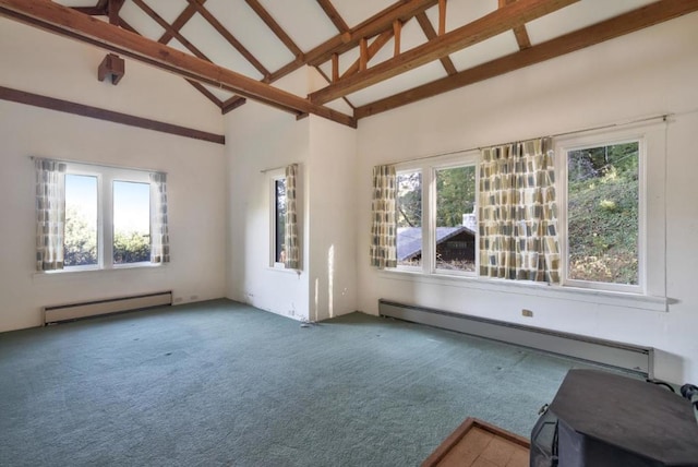 unfurnished living room with high vaulted ceiling, baseboard heating, and a wealth of natural light