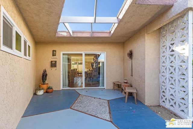 property entrance with a patio