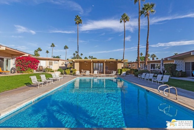 view of swimming pool featuring ceiling fan and a patio