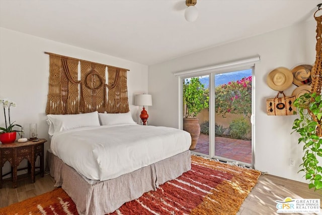 bedroom featuring hardwood / wood-style flooring and access to outside