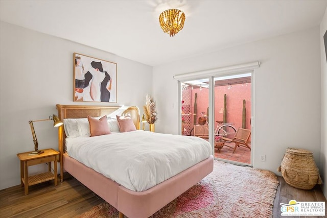 bedroom featuring dark wood-type flooring and access to outside