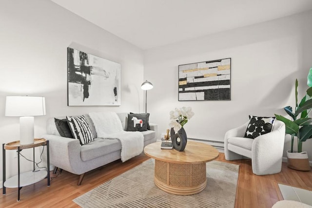 living room featuring baseboard heating and hardwood / wood-style floors