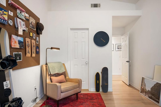 sitting room with hardwood / wood-style flooring