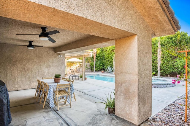 view of patio with ceiling fan, a swimming pool with hot tub, and a pergola