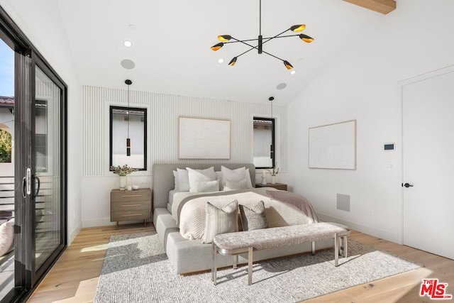 bedroom with high vaulted ceiling, a notable chandelier, and light hardwood / wood-style flooring