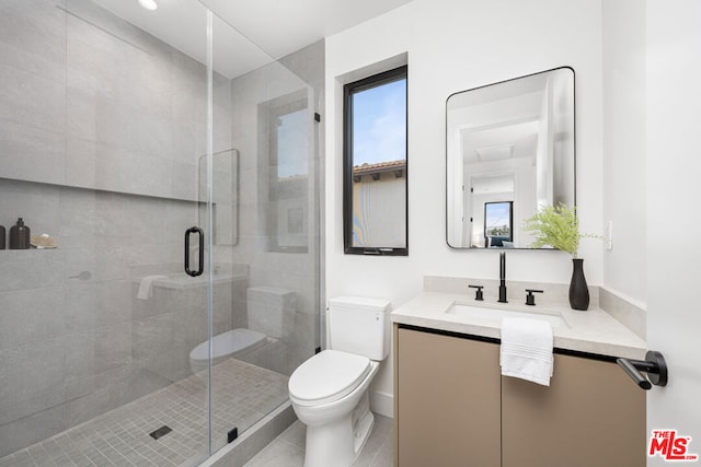 bathroom with toilet, walk in shower, plenty of natural light, and vanity