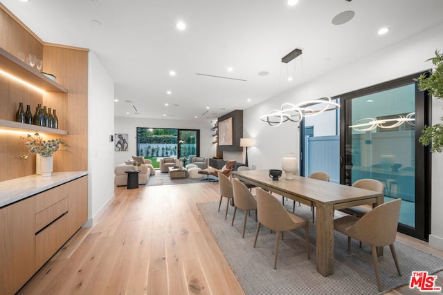 dining room with a chandelier and light hardwood / wood-style flooring