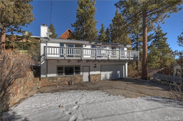 rear view of property featuring a garage