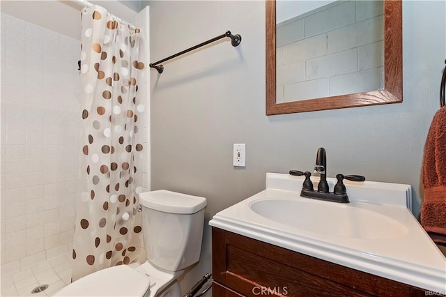 bathroom featuring toilet, vanity, and walk in shower