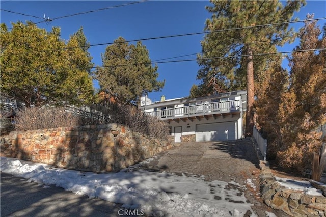 view of front of home with a garage and a balcony