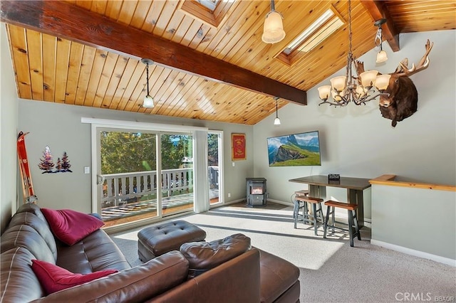 living room with lofted ceiling with skylight, carpet flooring, a wood stove, a chandelier, and wooden ceiling