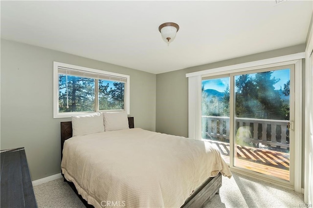 carpeted bedroom featuring access to outside