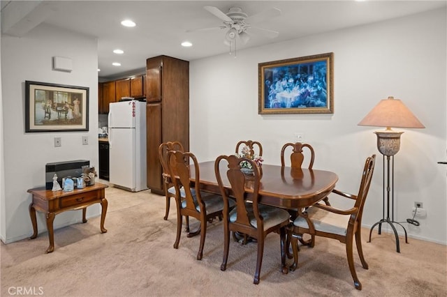 carpeted dining area featuring ceiling fan