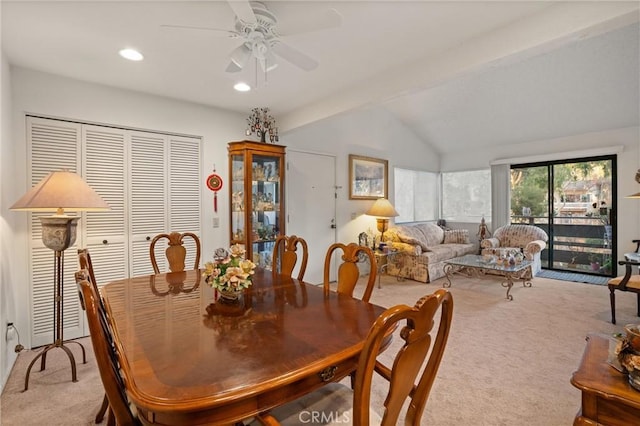 dining area with ceiling fan, lofted ceiling with beams, and light carpet