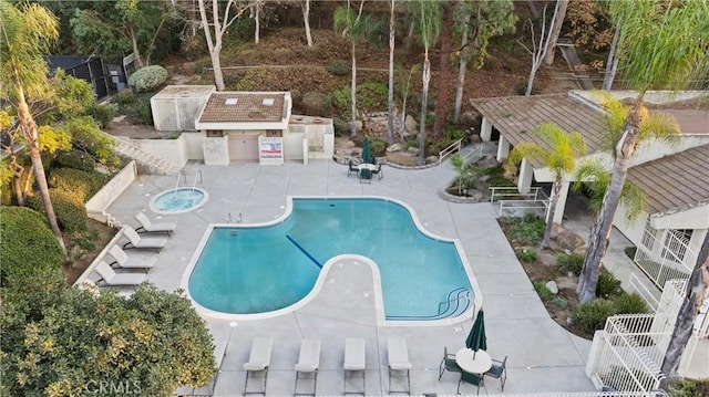 view of pool featuring a community hot tub and a patio area