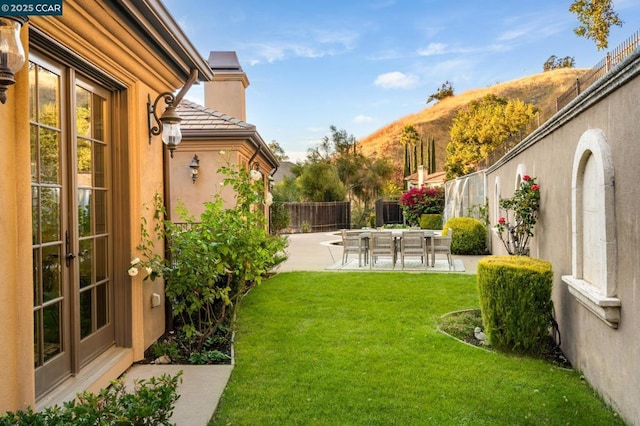 view of yard featuring a patio area and a mountain view