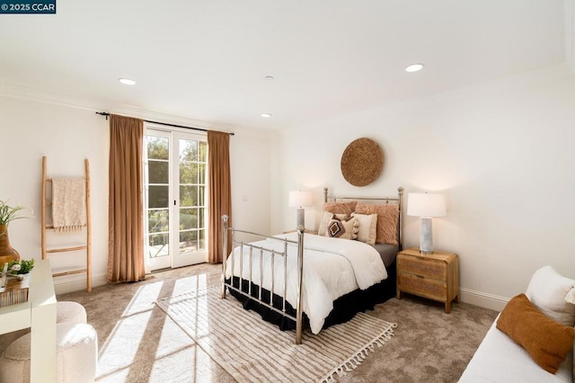 bedroom with light colored carpet, access to outside, and french doors