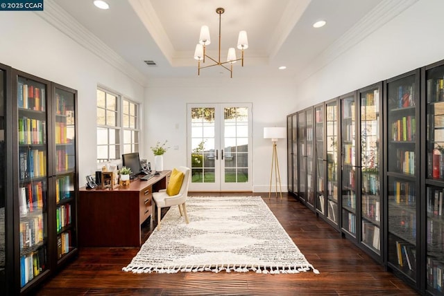 sitting room with french doors, dark hardwood / wood-style floors, ornamental molding, a chandelier, and a tray ceiling