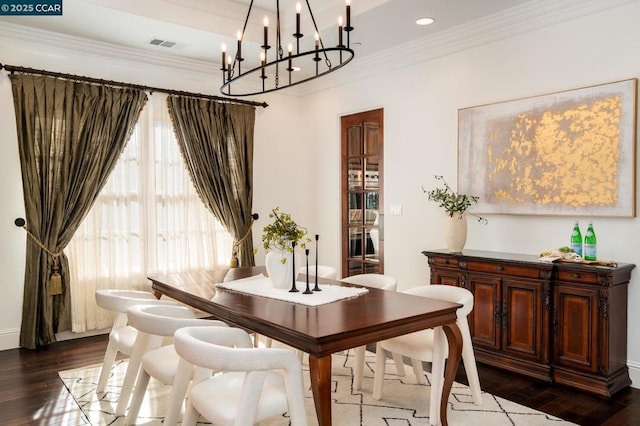 dining space featuring ornamental molding and dark hardwood / wood-style floors