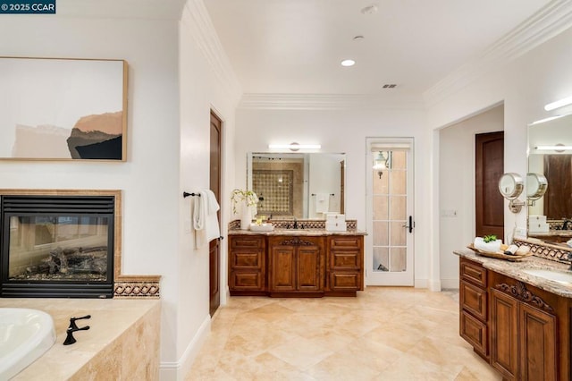 bathroom featuring tiled tub, vanity, and ornamental molding