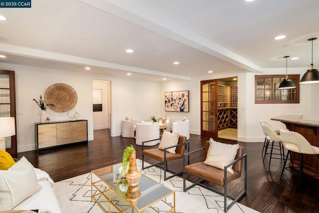 living room featuring beamed ceiling and hardwood / wood-style flooring