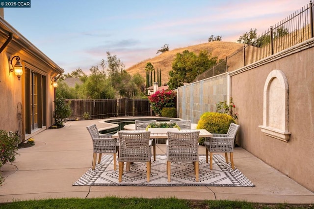 patio terrace at dusk with a mountain view