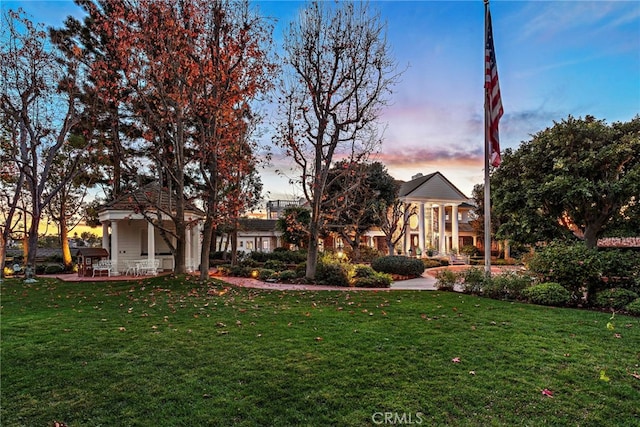 view of front of property featuring a yard and a patio