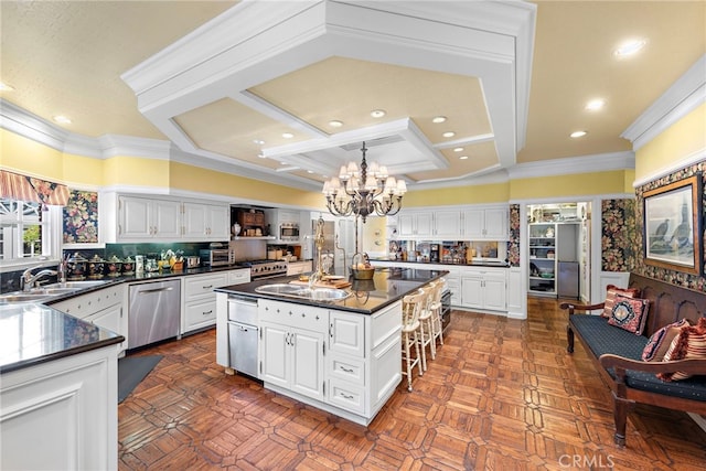 kitchen with white cabinetry, dishwasher, a kitchen island, a breakfast bar, and sink