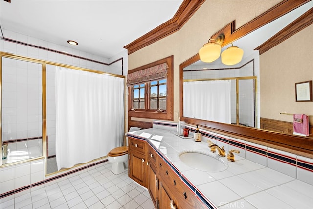 full bathroom featuring toilet, enclosed tub / shower combo, tile patterned flooring, ornamental molding, and vanity