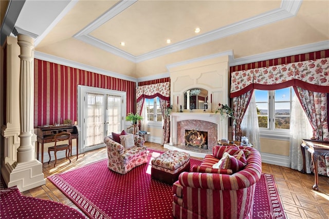 living room featuring a premium fireplace, a tray ceiling, french doors, parquet floors, and decorative columns