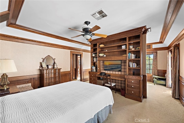 carpeted bedroom featuring ceiling fan and crown molding