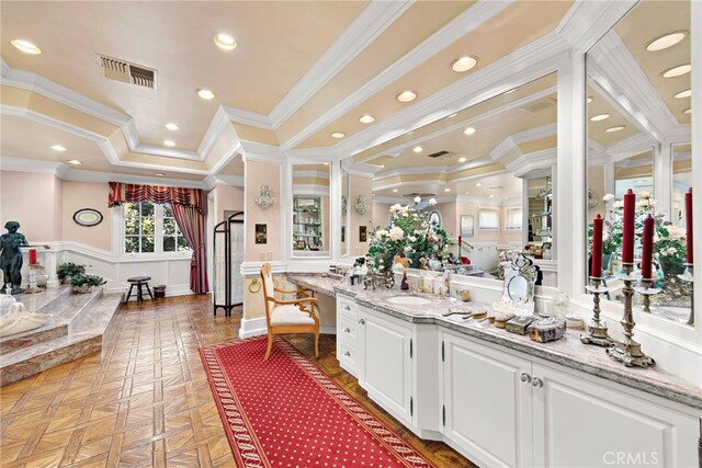 bathroom with crown molding, a raised ceiling, vanity, and parquet flooring