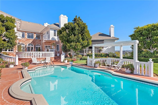 view of pool featuring a patio area and a pergola